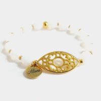 Pulsera elástica cristal de roca blanco y ojo filigrana baño oro.